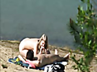 Extremely sexy blondie gives a head to her BF at public beach