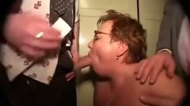 Red curly haired mature hooker works on several cocks at once