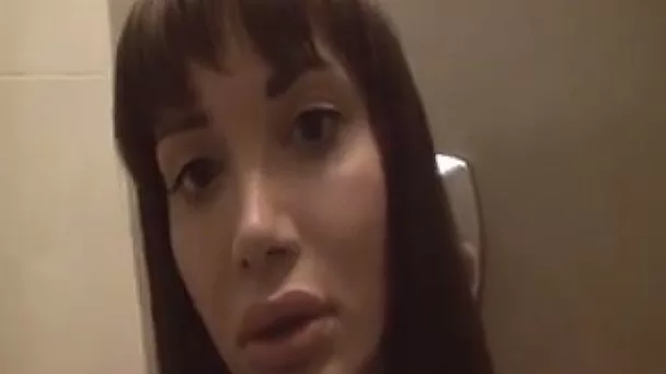 Lewd brunette shemale exposes her big boobies in the bathroom