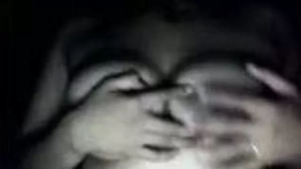 Girl presenting her big natural boobies in the dark