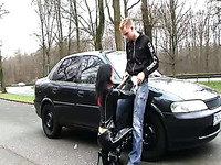 German latex slut serves her client near a car