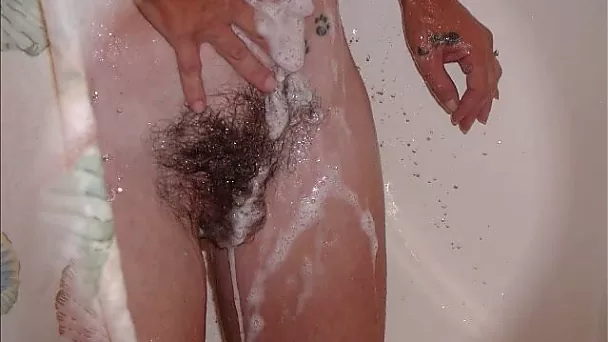 Naughty wife of mine loves flashing her impressive bush while taking shower