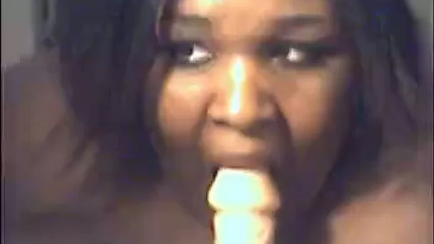Giant black mommy sucks her nipples and then takes big white dildo in her mouth