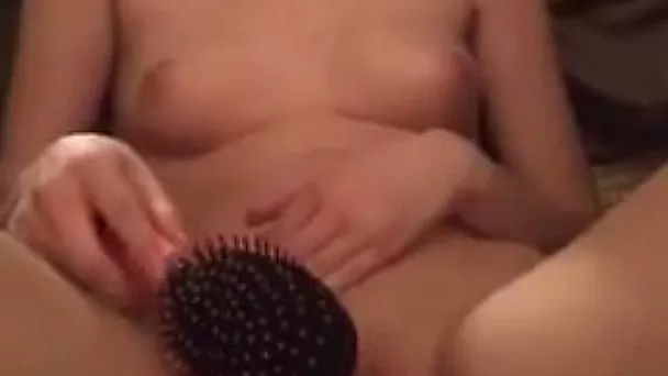 This small tittied webcam whore loves spanking her pussy with a hairbrush