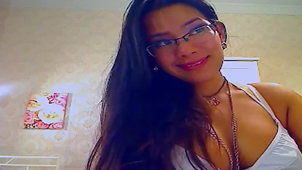 This Asian chick may wear glasses but she sucks her dildo like a pornstar