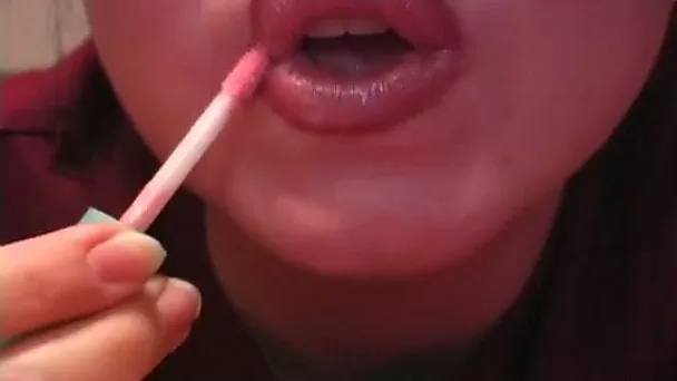 Watch amateur bitch putting on some lipstick on her sexy lips