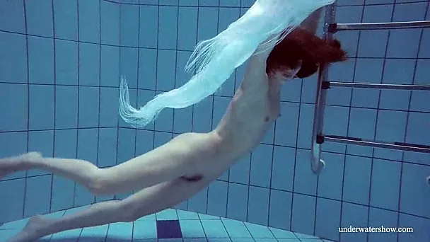 Flat chested chick is happy to demonstrate her bum while swimming