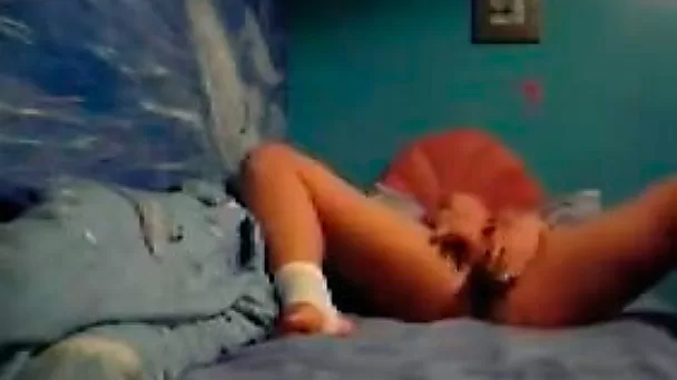 Horny and kinky slut with dark hair masturbating on the bed