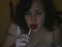 Mature mommy is sucking lollipop and pleasing her coochie with candy