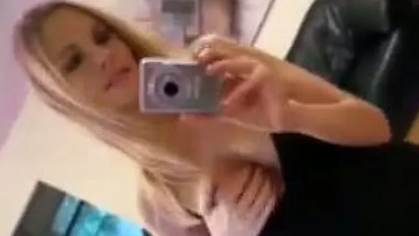 Lovely blonde doll strips in front of the mirror making hot amateur video