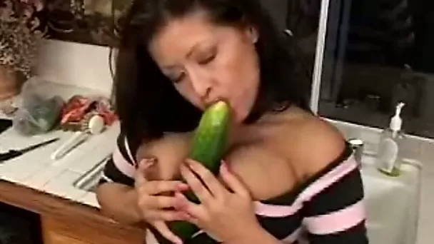 Using a cucumber tanned slutty amateur housewife masturbates