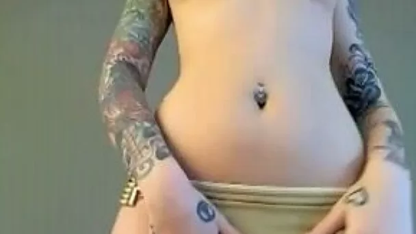 Ardent all tattooed brunette dances and exposes her rounded booty