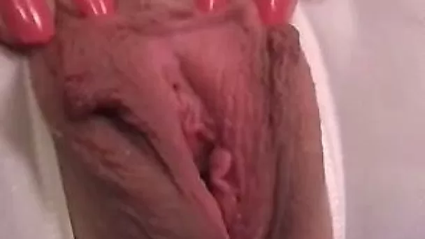 Stretching my loose pussy lips while making an amateur homemade porn video