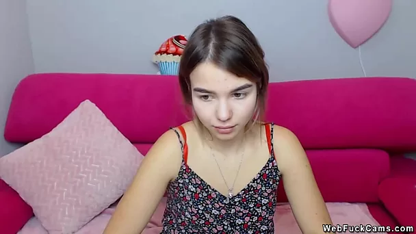 Dressed brunette teen camgirl posing
