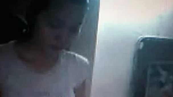 Some skinny Asian teen chick on webcam flashing her boobies