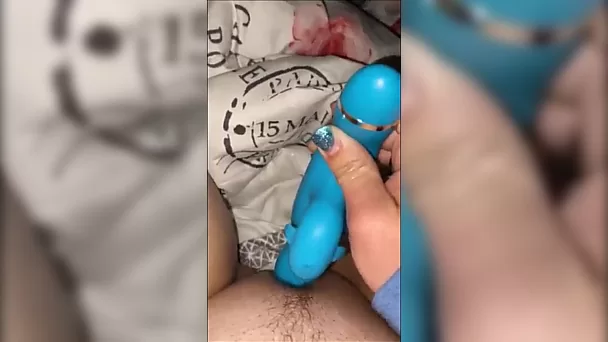 She uses a sex toy to masturbate next to me