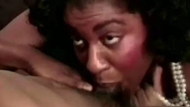 Cock hungry black milf greedily sucks a big black dick