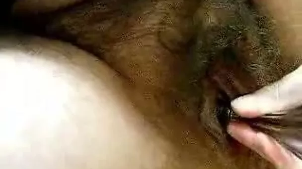 Tattooed brunette whore gets her hairy twat fucked with toy