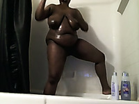 All oiled up ebony mature BBW in the bathroom showing off