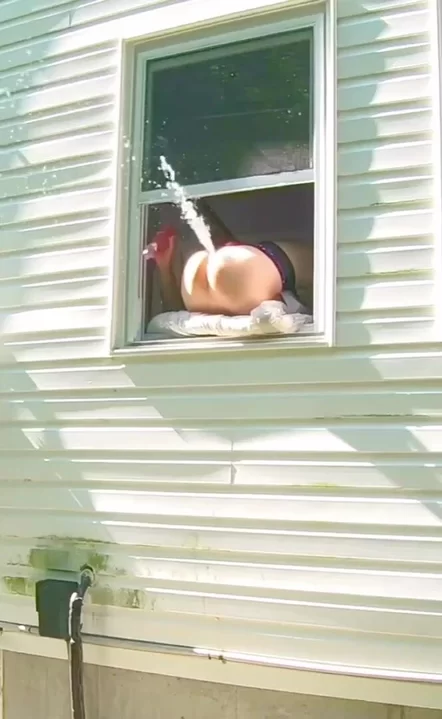 She’s grinding hard and squirting all over the window